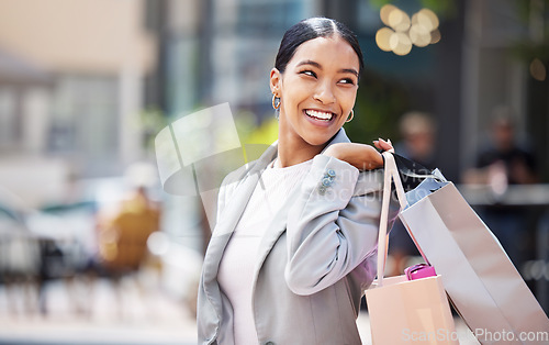 Image of Shopping, retail and customer with bags to shop at a store or mall in the city. Sale, money and consumer lifestyle with a happy, young woman spending, buying and purchase against an urban background