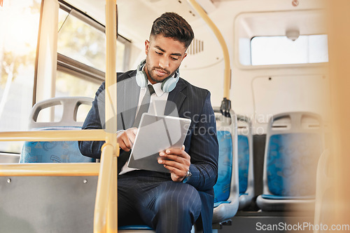 Image of Business man, using tablet and bus for travel to work, home or working location. Relax businessman using headphones, public transport to cbd and mobile device to update social media or check schedule