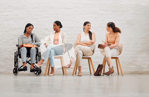 Image of Inclusive group of women sharing idea and goals, planning and talking, sitting together at work. Diverse creative team chatting, brainstorming, discussing an idea for a startup or marketing strategy