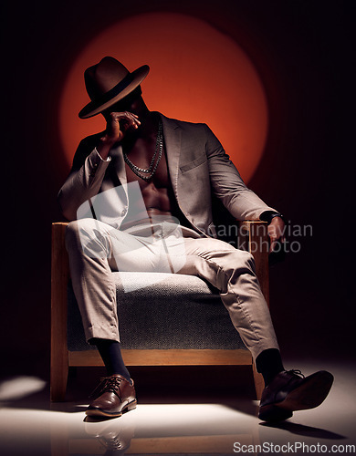 Image of Suit, formal and fashionable model with class, style and fashion in studio showing abs and body muscle with shadow. Artistic man in trendy, elegant or cool clothing showing power against background