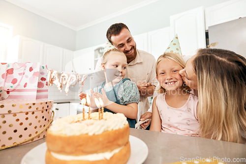 Image of Family birthday party, smile in home kitchen, happy mother kiss girl child, children love fun quality time together and bond over bake cake and food. Kid look at the camera of happiness in house.