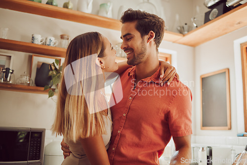 Image of Romance, happy and love couple hugging, smile and bonding in kitchen. Romantic boyfriend and girlfriend embracing, enjoying their relationship and being carefree together.