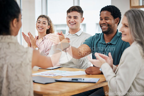 Image of Creative team in meeting clapping and giving a handshake for a promotion and welcome. Diversity, professional and corporate group celebrating successful teamwork in corporate office boardroom.