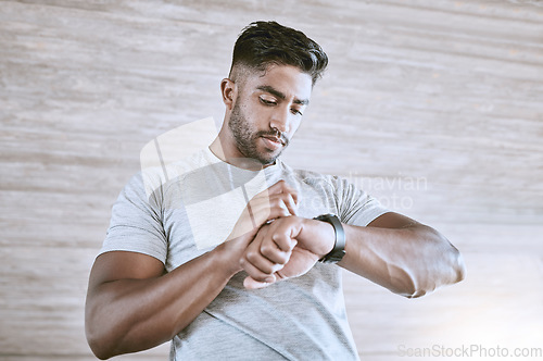 Image of Man with digital smartwatch for health, fitness and performance progress tracking after exercise or training. Strong and healthy young man or athlete check with tracker watch for time and heart pulse