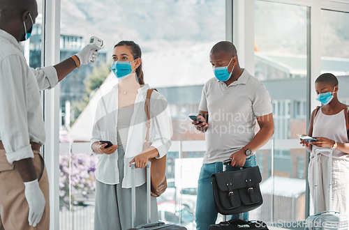 Image of Covid, travel and healthcare worker testing the temperature of people to board a flight at an airport. A nurse, health and safety with travelers in masks getting tested for corona to get on a plane.