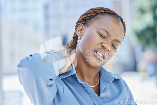 Image of Woman manager with stress and pain in her neck while standing outside the office building. Female business leader at work with aching muscle in need of a wellness massage or a medical doctor for help