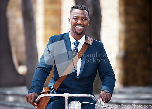 Image of Portrait of a happy businessman on bike or bicycle on his morning travel into work in the city. Employee,, entrepreneur or worker on the ride with decrease his carbon footprint with a suite and smile