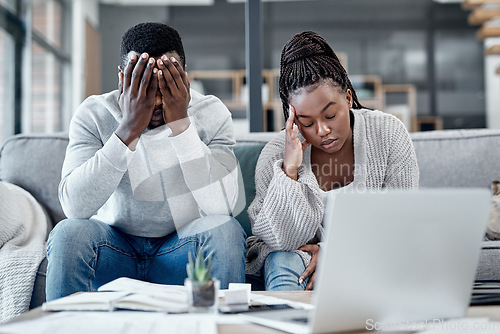 Image of Stress, anxiety and worry with a young couple struggling with finance, debt and the home budget in the living room. Man and woman feeling negative and depressed with inflation and loan repayment
