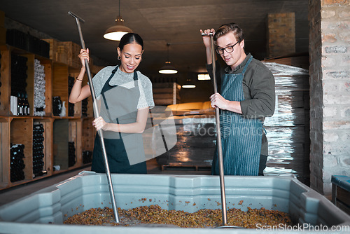 Image of Production, manufacturing worker and teamwork in wine industry and labor press tool for fermentation of grape fruit alcohol. Sommelier people working in winery, distillery or warehouse at a vineyard