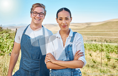 Image of Couple farming on a wine farm in summer, farmer gardening on a vineyard or field and smile with green sustainable lifestyle. Portrait of interracial man and woman with arms crossed for agriculture