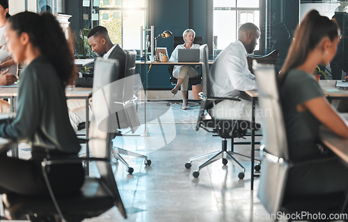 Image of Corporate, modern office and diversity of business people working at their desk with the company CEO. Female leader working on her laptop. Busy staff working on projects in a professional workplace.