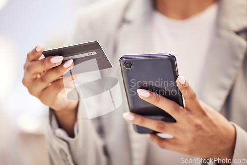 Image of Ecommerce, fintech business woman with smartphone and credit card doing financial payment, online shopping or banking. Corporate finance hands using a secure and safe digital banking app or software