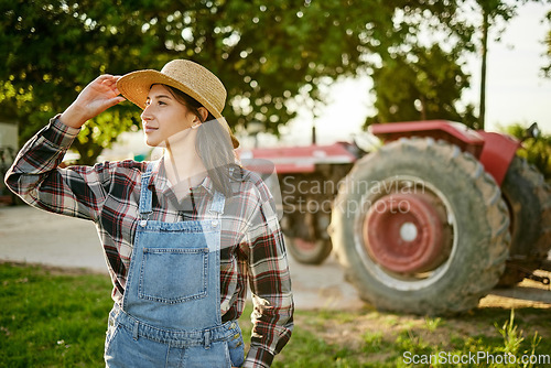 Image of Farm, tractor and a woman in a hat in nature or field farming food, fruits and vegetables. Agriculture and natural environment with farmer in the countryside in the summer sun working on harvest