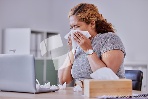 Image of flu, covid and sick corporate employee suffering with a cold or flu, working on laptop, blow nose or sneezing in an office. Young assistant experience allergy, sinus, illness or disease symptoms