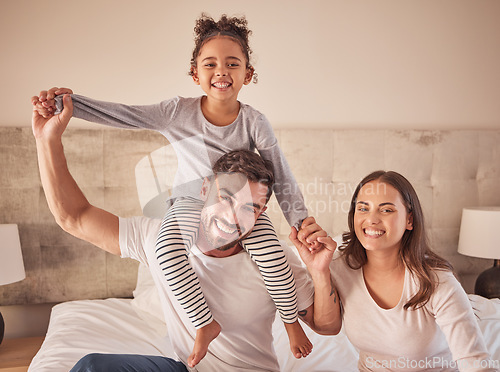 Image of Family, mother and father with happy girl sitting in bedroom together spending quality time relaxing at home. Smile, parents and freedom with young child on dads shoulders next to mom in portrait