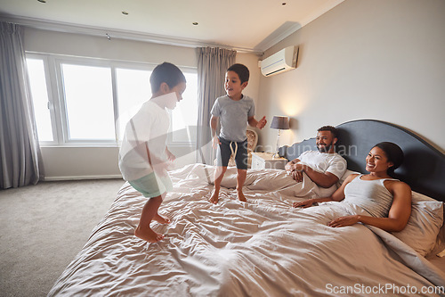 Image of Mother, father and children jump on bed or bedroom and wake up happy together in family home in the morning. Happiness, love and smile of kids with parents in a house for real estate or holiday