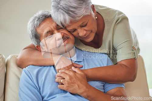 Image of Sad or unhappy senior couple hug, comfort or support in a living room at home. Elderly husband suffering from depression problem after retirement consoled by his wife with love in the living room.