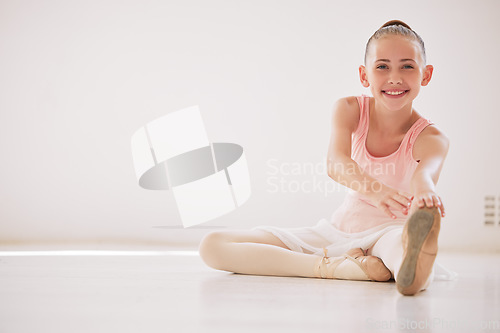 Image of Happy ballet dancer girl stretching on the floor in a dance studio with mockup white background. Portrait ballerina kid smile while learning or training with legs in class for a performance mock up