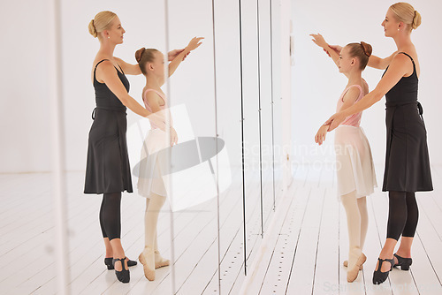 Image of Ballet education, teacher and girl dancer learning on mirror from her instructor in professional art studio hall. Dancing coach training ballerina student on balance at performance academy class