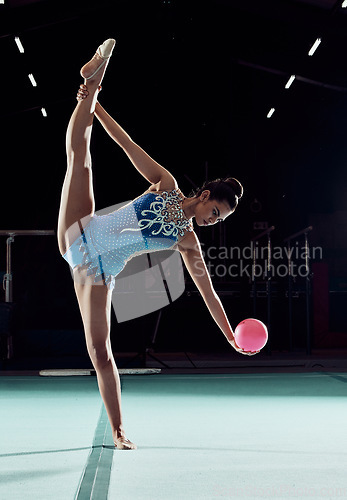 Image of Fitness, sports and training for a woman gymnast with ball, in professional arena. Exercise, motivation and energy for a girl in a gymnastics competition. Performance with rhythm, beauty and balance.