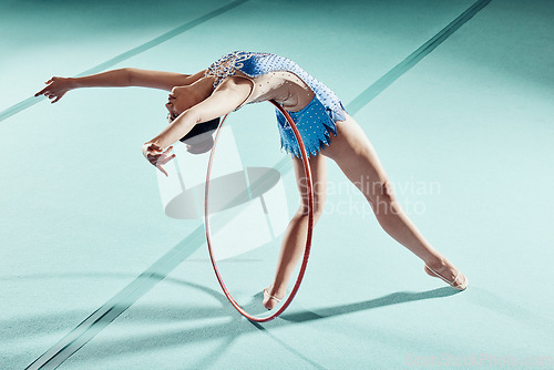 Image of Sports woman, performance and balance ring for gymnastics show. Fitness girl doing artistic pose and stretch for acrobat stunt. Young and beautiful athlete in gym with hula hoop and flexible body.