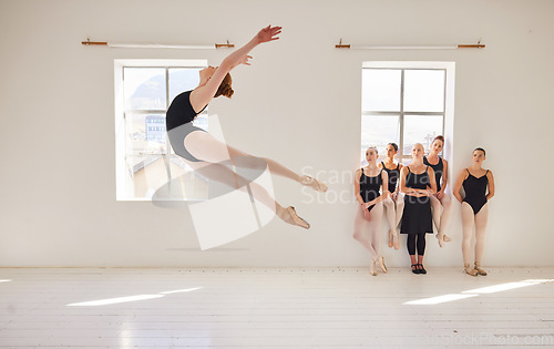 Image of Dance studio, ballet and jump in air while class watches girl student move with agility and grace. Ballerina woman with talent and good body coordination in training lesson with youth dance team.