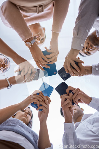 Image of Social media, smartphone and business people networking with a global community using technology together. Group and team typing, surfing and searching online on web communication app from below view