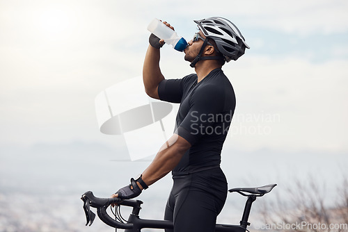 Image of Sports man with a bike drinking water bottle doing fitness training or workout on sky mockup background. Healthy, professional athlete cyclist with a bicycle during cycling cardio exercise in nature