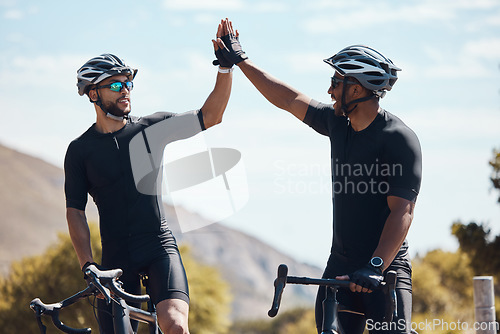 Image of High five, winner and cycling team of cyclists having fun riding together outdoors in nature. Happy, excited and fit male bicycle riders on a break after exercising and training in the environment