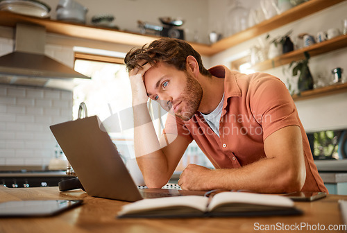 Image of Stress, laptop finance and planning man thinking of home loan, investment savings and future money growth goals in house kitchen. Anxiety, burnout or sad guy with debt depression after trading budget