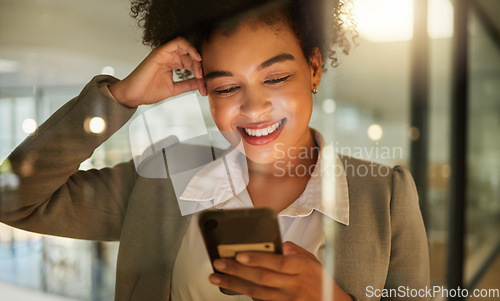 Image of Business woman on a phone networking on social media, reading a blog or research in corporate office. Working lady browsing internet, company website or mobile app. Happy female texting on smartphone