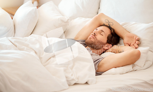 Image of Relax, home and bed room for sleeping man lying on morning in house bedroom, hotel or luxury airbnb hospitality. Fatigue, burnout or tired person resting, dreaming or calm in healthy comfort blanket