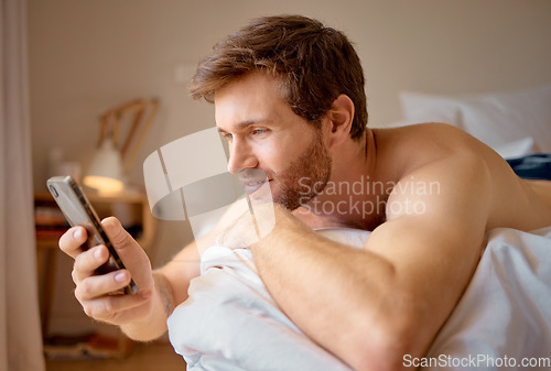 Image of Phone web dating app search, internet streaming or texting of an attractive man in a bedroom bed. Digital, online and social media on a 5g mobile while a guy relax at a house with technology