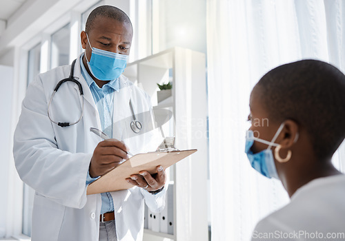 Image of Covid doctor or medical worker consulting a patient for and writing health information at the hospital. Healthcare man working on insurance, paper or checklist for a woman at a clinic