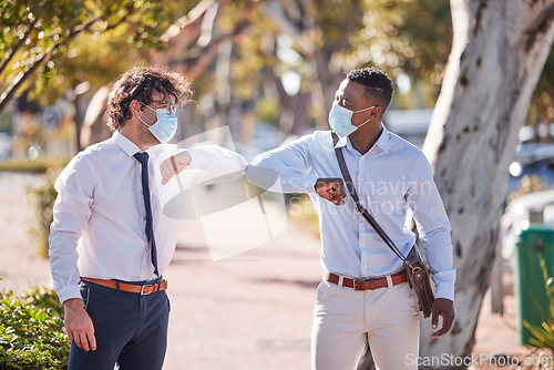 Image of Businessmen elbow greeting in covid 19 masks outside in a parking lot showing teamwork and diversity in summer. Sun, world and social safety protocol by people who work for a global corporate company