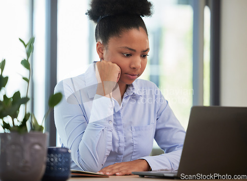 Image of Serious, frustrated and thinking while waiting and working on a laptop with slow internet or wifi connection in an office. Black female entrepreneur looking worried about mistake or glitch online