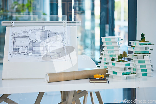 Image of Architecture, blueprints and model building design in empty architectural company office. Vision engineering, real estate or residential planning with 3D structure for luxury apartment infrastructure