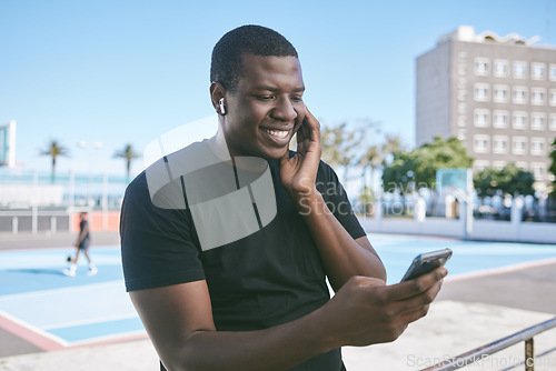 Image of Black entrepreneur on social media and phone listening audio with wireless earphones in city street. Ecommerce tech, online shopping, video call read emails and happy freelance worker man outdoors.