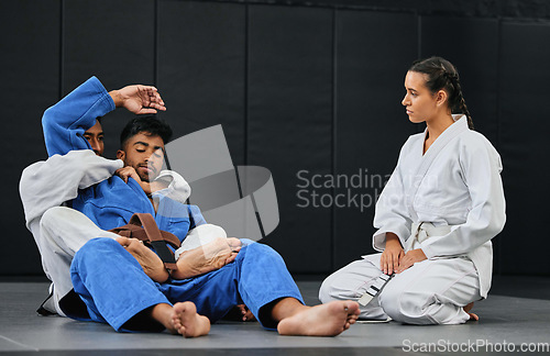 Image of Group of athletes in a martial arts fight workout for fitness at a training studio. Active, fit and diverse team of sporty people practicing sparring in taekwondo or jujutsu at an exercise dojo.