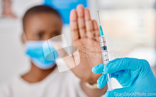 Image of Vaccine hesitancy, covid and female patient stopping doctor from giving the injection at the clinic. Woman refusing to take the vaccination while a healthcare worker prepares the needle and syringe.