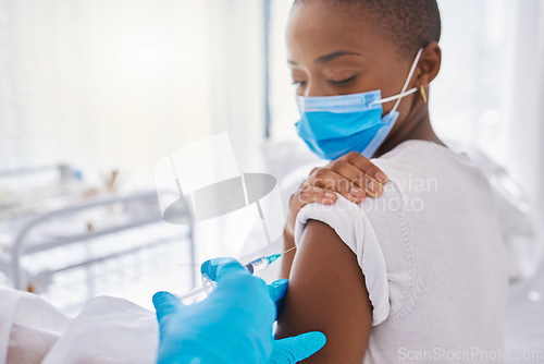 Image of Vaccine, medicine and covid injection at a clinic by a young black woman wearing a covid19 mask. Ill, sick or unhealthy young female getting flu shot or coronavirus treatment at a hospital