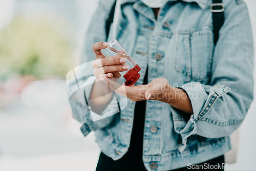 Image of Closeup of woman using hand sanitizer while in public or travelling with copy space. Female practicing good health and hygiene, sticking to corona regulations. Lady suffering from OCD or germ phobia