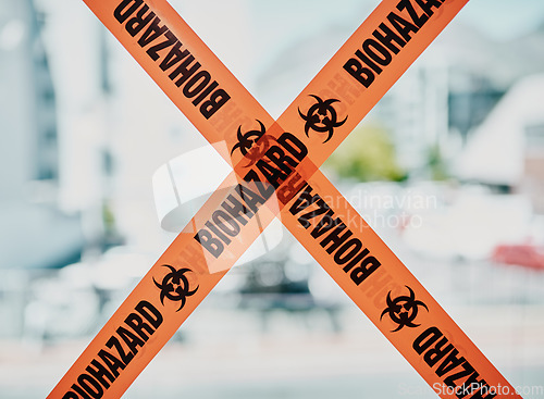 Image of Biohazard caution, danger barrier tape of a quarantine zone. Bright orange safety stripes across infected area, no entry or cross, room closed down for cleaning and inspection over copy space.