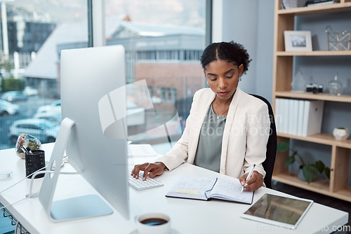 Image of Finance manager writing notes, typing on a computer keyboard and planning to check financial data in office. Serious boss thinking, arranging tax deadlines or scheduling business meetings in notebook