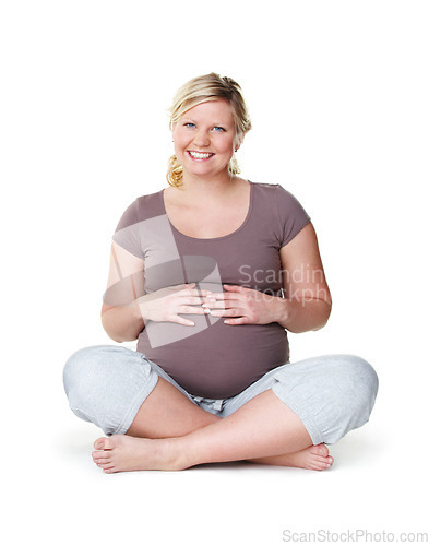 Image of Pregnant, happy and healthy woman sitting with her hands on her stomach while enjoying her pregnancy against a white background. Health, wellness and hope of a mother to be ready for childbirth