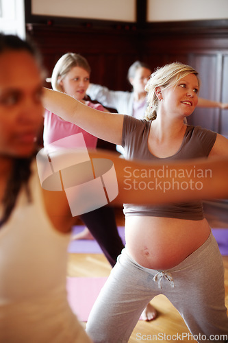 Image of Pregnant, yoga and woman doing pilates or health fitness exercise in a class workout studio. Pregnant woman or mother abdomen, doing cardio for pregnancy wellness or healthy motivation in yoga class