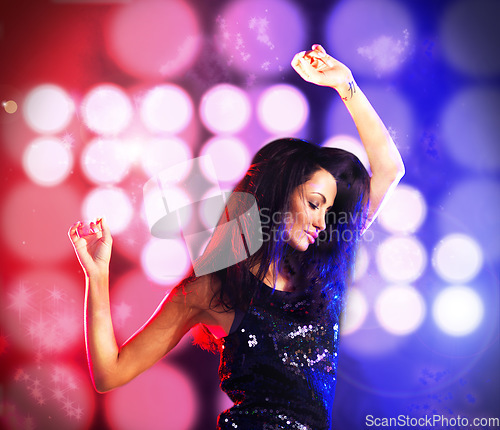 Image of Sexy woman dancing in disco or club party with color light in background with energy to dj music. Young crazy female dancer on the dance floor at night in techno rave or nightclub at a fun event