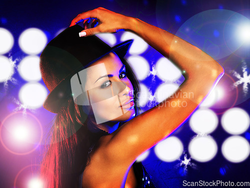 Image of Disco party, light and woman in a club at night dancing alone on rave dance floor in lens flare portrait. Sexy, techno and young girl in fun nightclub, concert or house music event for celebration