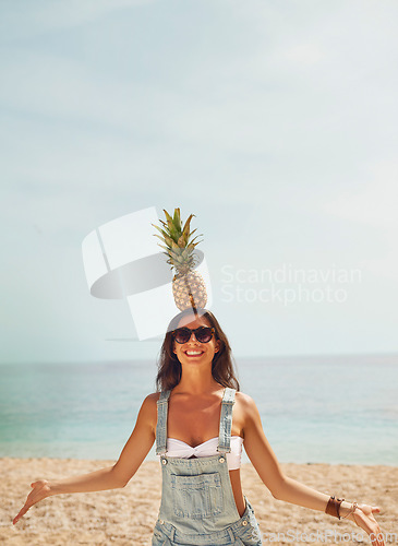 Image of Exotic Pineapple fruit balancing on head of beautiful girl symbol of summer beach vacation healthy organic diet food