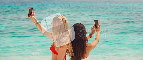 Image of Beautiful girl friends taking selfies with smart phone technology on paradise beach destination summer wanderlust vacation